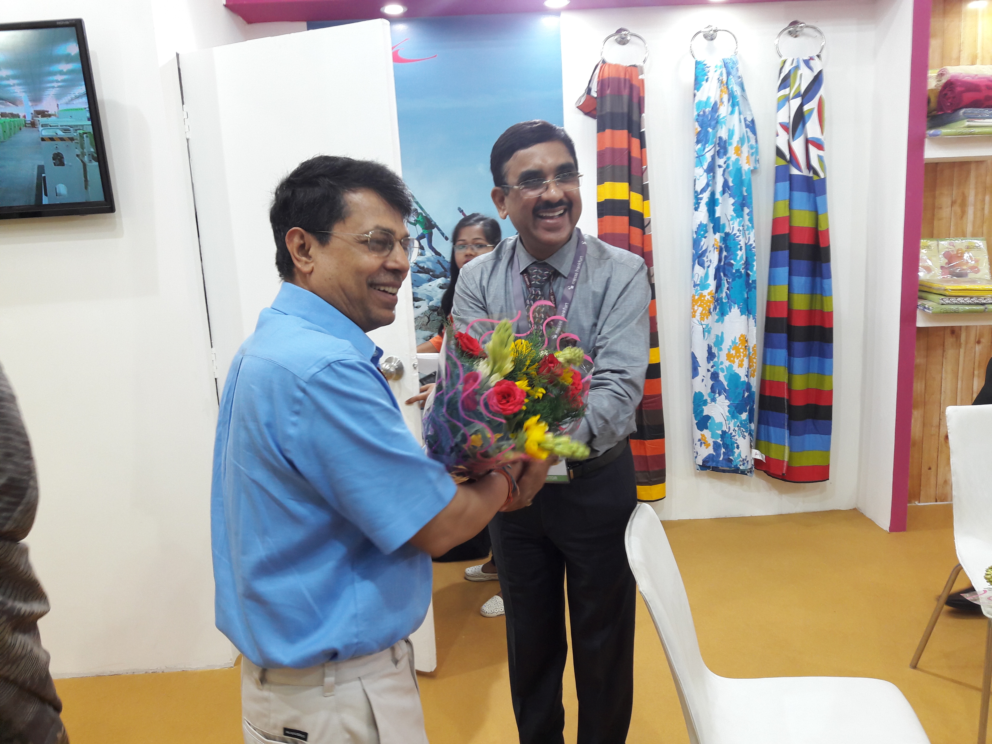 Shri P.C Vaish, CMD, NTCL welcoming Development Commisioner (Handicrafts) to NTCL Stallwith a bouquet of Flowers.